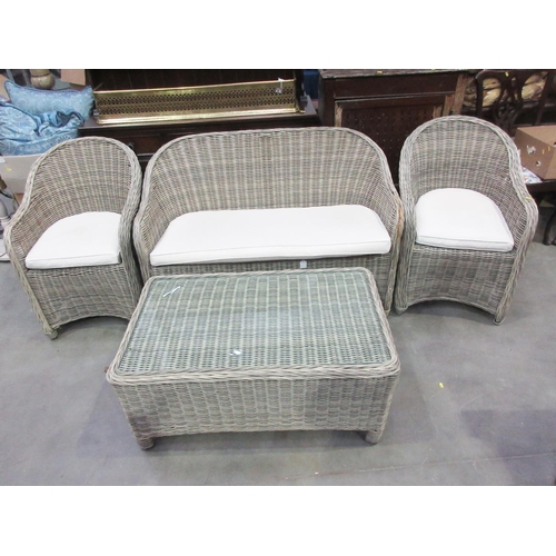 385 - A wicker Conservatory Suite of Sofa 4ft W, two Armchairs 1ft 11in W and a glass topped Coffee Table ... 