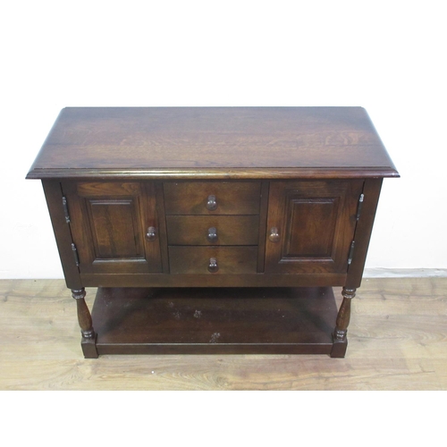 401 - A reproduction oak Side Cupboard fitted pairof panelled doors flanking three drawers 3ft W