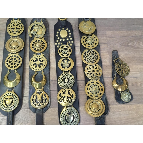 422 - A collection of Horse Brasses on leather straps