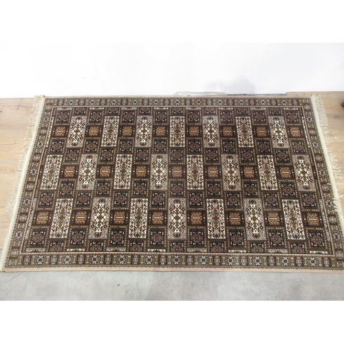 452 - A large cream and brown ground Rug with multiple square and rectangular geometric patterns, 94 x 54 ... 