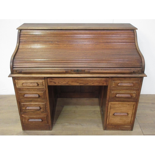 502 - An oak tambour fronted Desk fitted seven drawers 4ft 4in W x 3ft 8in H