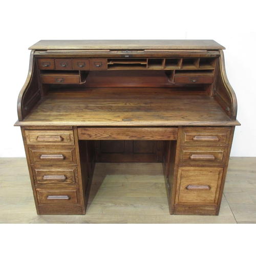 502 - An oak tambour fronted Desk fitted seven drawers 4ft 4in W x 3ft 8in H