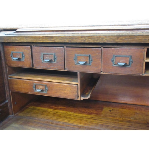 502 - An oak tambour fronted Desk fitted seven drawers 4ft 4in W x 3ft 8in H