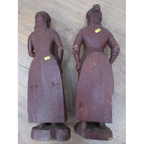 515 - Two antique carved Figures of peasant women in 17th Century dress 1ft 11in and 1ft 10in H, possibly ... 