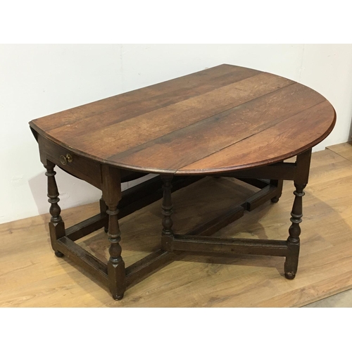 518 - An early 18th Century oak Gateleg Dining Table fitted single end drawer mounted upon baluster turned... 