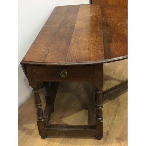 518 - An early 18th Century oak Gateleg Dining Table fitted single end drawer mounted upon baluster turned... 