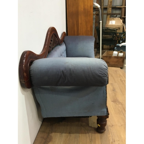 520 - A Victorian mahogany framed  hump back Sofa with leafage carved top rail and blue upholstery (missin... 