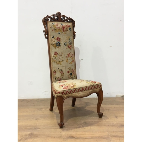 534 - A Victorian rosewood Prayer Chair, with carved crest, tapestry back and seat on cabriole front suppo... 