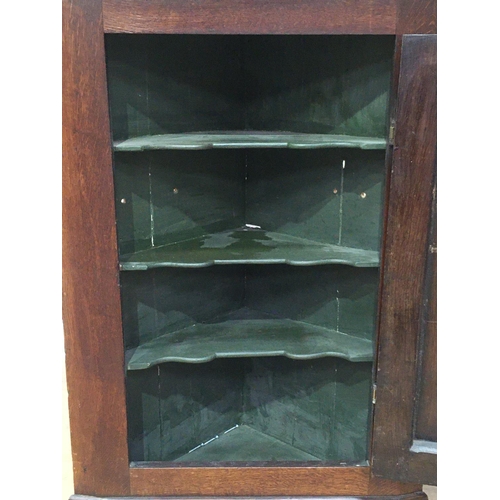 547 - An antique oak hanging Corner Cupboard, the single door enclosing shaped shelves, 3ft 1in H x 2ft W