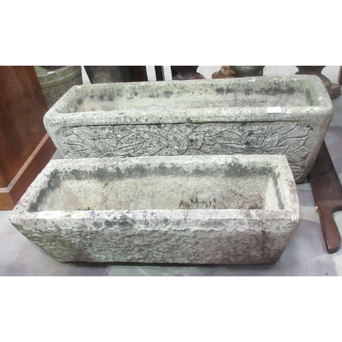 550 - Two rectangular Troughs, one with floral designs, 2ft 6in and 1ft 11in and two composite stone Plint... 