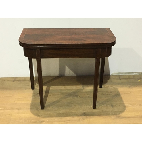 553 - A 19th Century mahogany Tea Table with crossbanded fold-over top raised on squared tapering supports... 