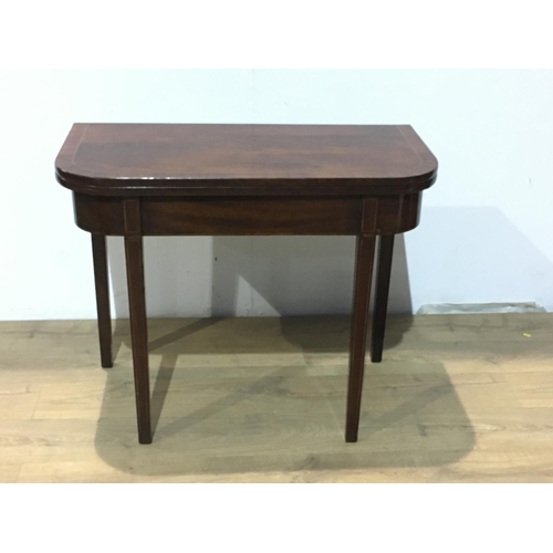 553 - A 19th Century mahogany Tea Table with crossbanded fold-over top raised on squared tapering supports... 