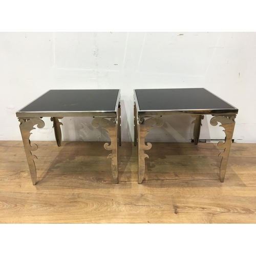 671 - A pair of modern square Coffee Tables with black glass tops inset within polished metal frames and s... 