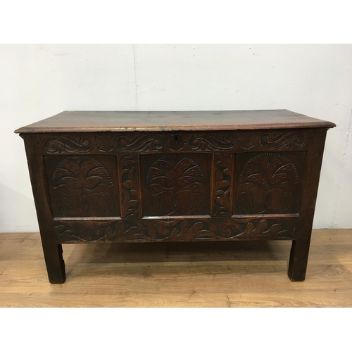 674 - A 17th Century oak Coffer with plank lid above three panel front carved with fritillaries mounted up... 