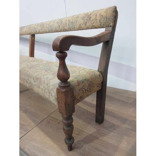 744 - A 19th Century pine Club Settle with upholstered back and seat mounted on turned front supports A/F ... 