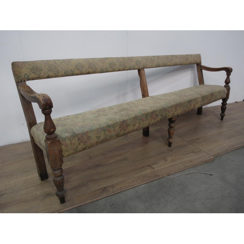 745 - A 19th Century pine Club Settle with upholstered back and seat mounted on turned front supports A/F ... 