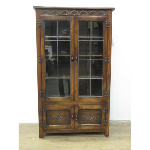 98 - An oak Bookcase fitted pair of lead glazed doors 5ft 1in H x 3ft W