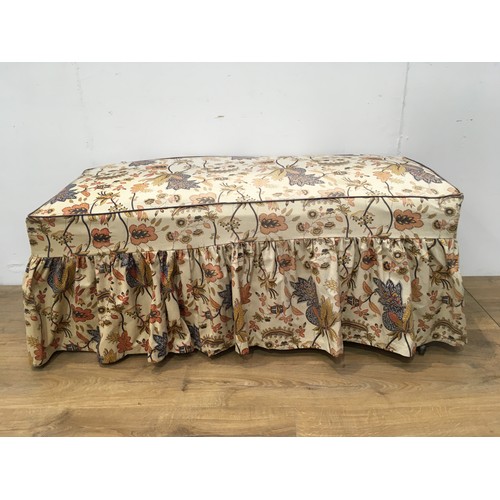 61 - An antique Ottomon with hinged lid and floral decorated loose cover mounted on brass casters 4ft 3in... 