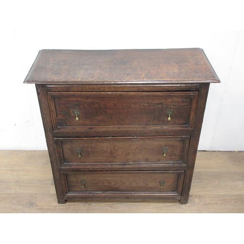 103 - An antique moulded oak Chest of three drawers with dropper handles mounted on stile supports, utlisi... 