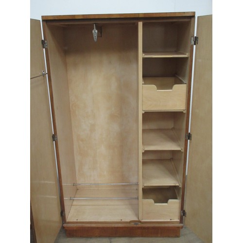 106 - An Art Deco walnut veneered Compactum Wardrobe fitted two doors enclosing hanging space, shelves and... 