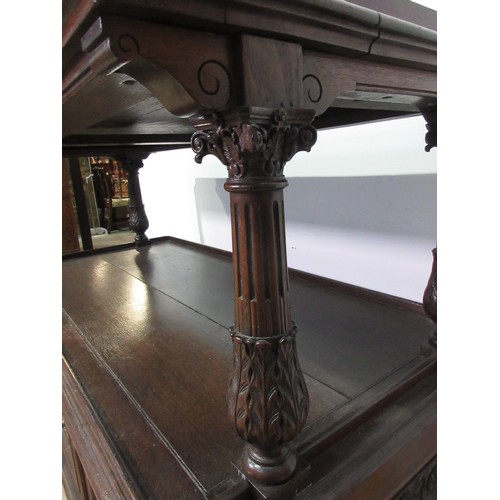 446 - A 19th Century oak Buffet with leafage carved corinthian column supports above base fitted three dee... 