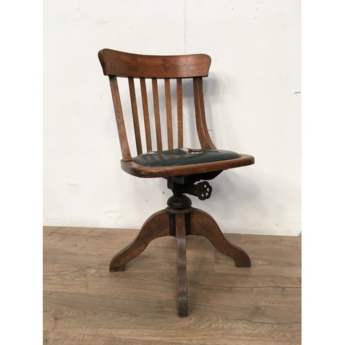 562 - An oak swivel Office Chair, upholstered seat A/F