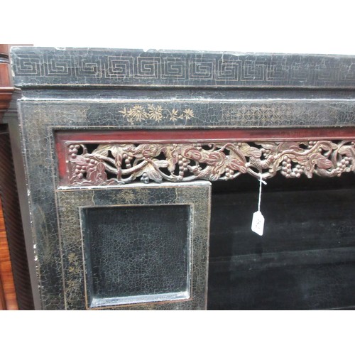 752 - An antique Chinese chinoisserie black lacquered Cabinet with beast and fruiting grape pierced frieze... 