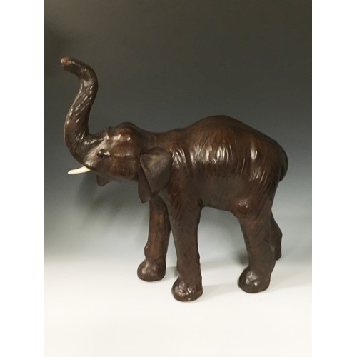 94 - A leather covered Figure of an Elephant with raised trunk 1ft 8in H