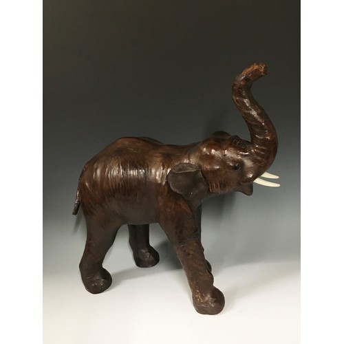 94 - A leather covered Figure of an Elephant with raised trunk 1ft 8in H