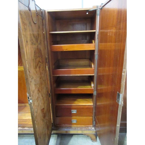 336 - An Art Deco figured walnut three door Wardrobe fitted drawers and slides to the one section, 6ft 2in... 