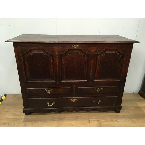 774 - An 18th Century oak Mule Chest with hinged lid above crossbanded frieze and three shaped panels, two... 