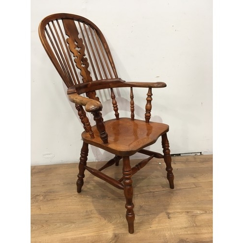 773 - A 19th Century yew and elm Windsor Elbow Chair with pierced splat and stick back, solid seat on turn... 