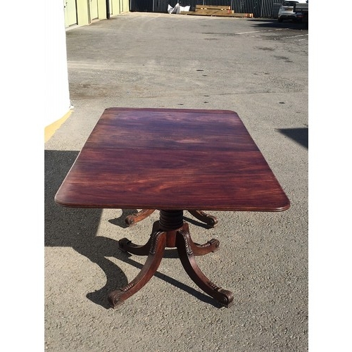 787 - A Regency mahogany twin pedestal Dining Table on ring turned colums each with four acanthus leaf car... 