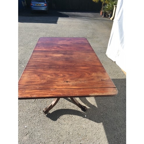 787 - A Regency mahogany twin pedestal Dining Table on ring turned colums each with four acanthus leaf car... 