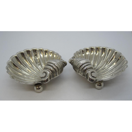 150 - A pair of Victorian silver scallop shape Salts on ball feet, Chester 1894.