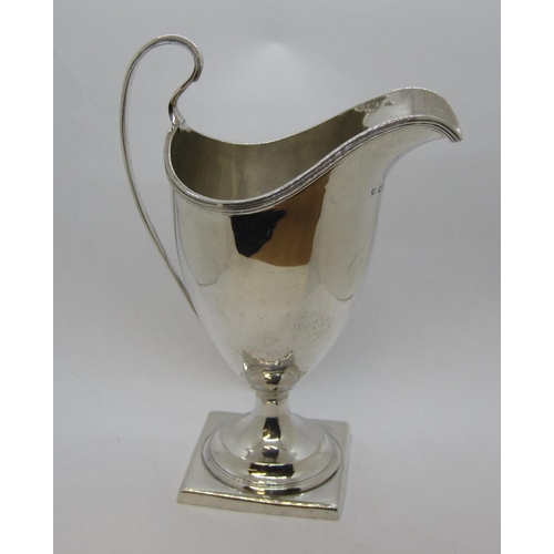 151 - A George III silver helmet shape Cream Jug with reeded rim on square base, London 1796.