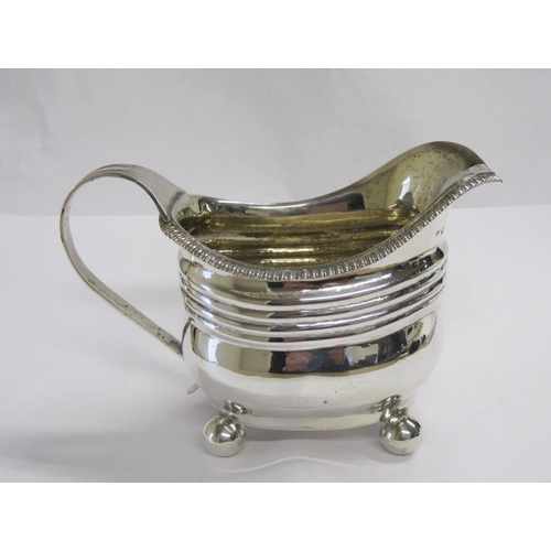 167 - A George III silver boat shape Milk Jug, engraved initials, on ball feet, London 1814.