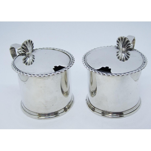 190 - A pair of Edward VII silver drum Mustard Pots with gadroon rims, blue glass liners, Chester 1905.