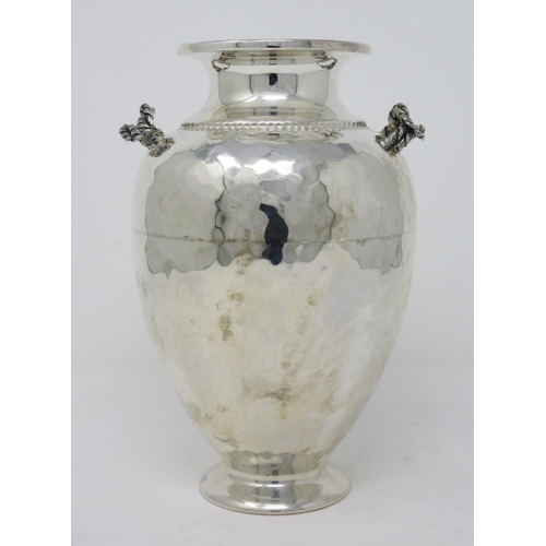 199 - A Greek silver baluster Vase with hammered design and rope twist handles, 7 1/2in