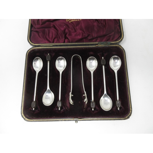 203 - Six George VI silver bean handled Coffee Spoons, Sheffield 1939 and a pair of plated Sugar Claws, in... 