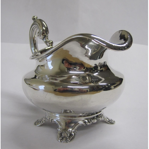 247 - A William IV silver Jug of compressed circular form on four shell and scroll feet, London 1835.