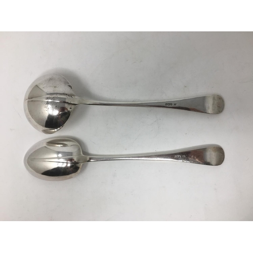 259 - A George V silver Soup Ladle and large Basting Spoon, hanoverian pattern engraved initial, Sheffield... 