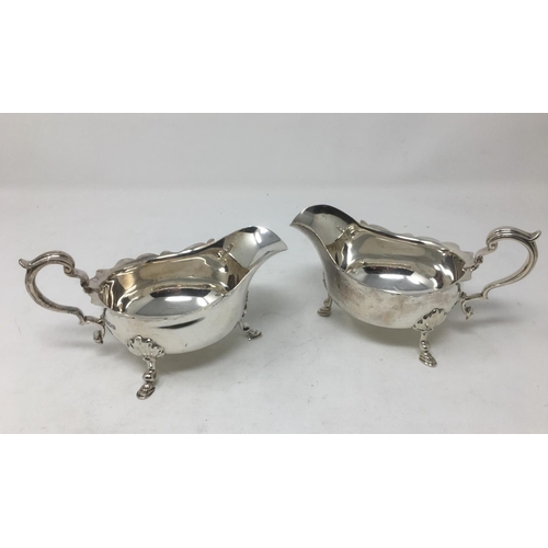 260 - A pair of George V silver Sauce Boats, with shaped rims, leafage scroll handles on hoof feet, Sheffi... 