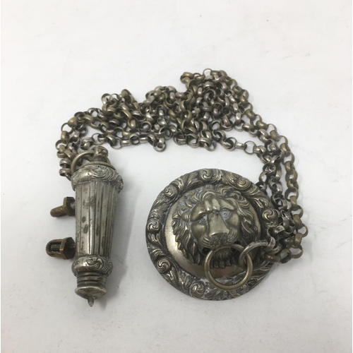 273 - A white metal Bosun’s Whistle and Holder attached to a chain with lion mask having ring holder.