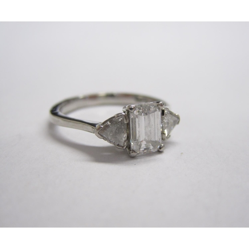 308 - A Diamond three-stone Ring, corner claw-set emerald-cut stone, 1.01cts, between two trilliant-cut st... 