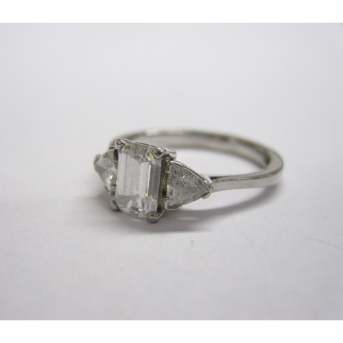 308 - A Diamond three-stone Ring, corner claw-set emerald-cut stone, 1.01cts, between two trilliant-cut st... 