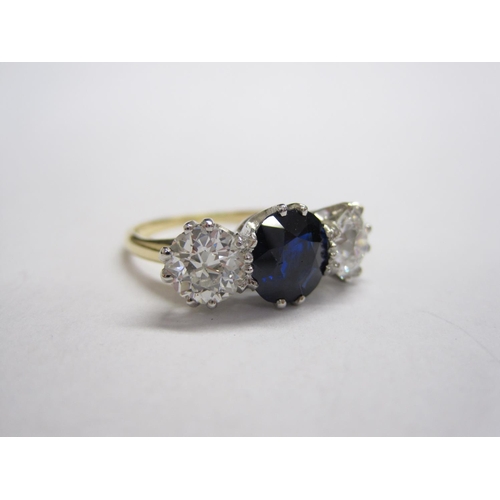 314 - A Sapphire and Diamond three-stone Ring, claw-set cushion-cut unheated sapphire, 1.99cts, between tw... 