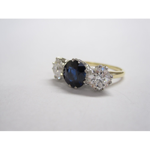 314 - A Sapphire and Diamond three-stone Ring, claw-set cushion-cut unheated sapphire, 1.99cts, between tw... 