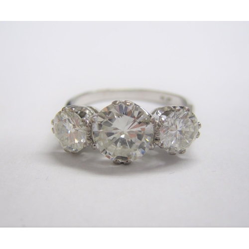 319 - A Diamond three-stone Ring, claw-set graduated brilliant-cut stones, estimated total diamond weight ... 