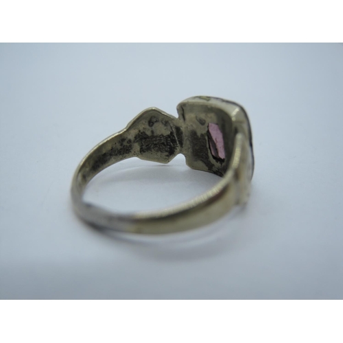 328 - An antique Ring, rubover-set purple stone, shoulders engraved flowers, ring size K, A/F.